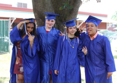 A group of people in graduation gowns posing for a photo.