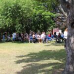 A group of people sitting in a park.