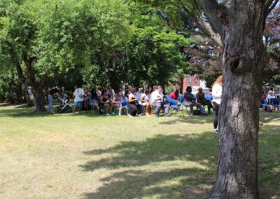 A group of people sitting in a park.