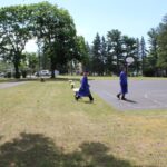 A group of people playing basketball in a park.