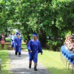 A group of people walking down a path.