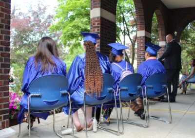 A group of people sitting in chairs at a graduation ceremony.