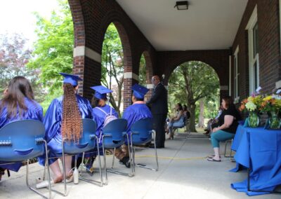 A group of people sitting on chairs at a graduation ceremony.