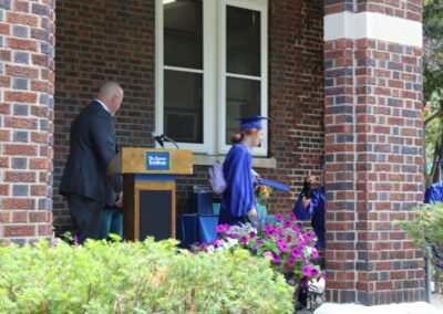 A group of people standing in front of a brick building.