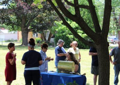 A group of people standing around a table.