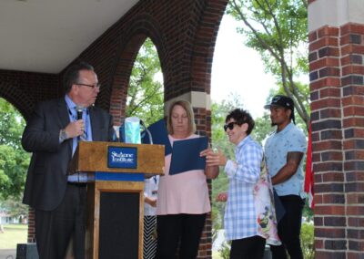 A group of people standing at a podium.