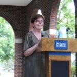 A woman standing at a podium.
