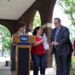 A group of people standing at a podium.