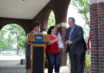 A group of people standing at a podium.