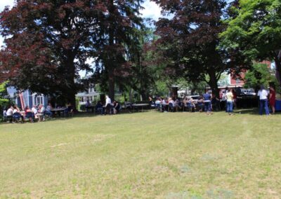 A group of people standing in a grassy area.