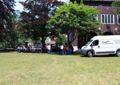 A white van parked in a grassy area.