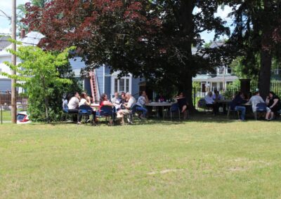 A group of people sitting in a grassy area.