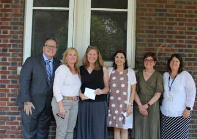 A group of people standing in front of a brick building.