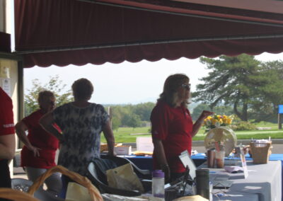 A group of people standing around a table.