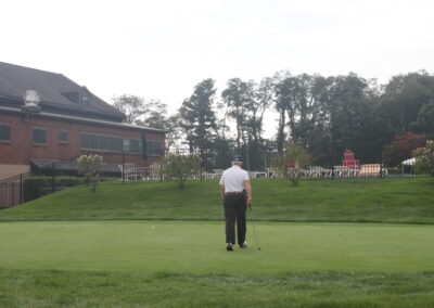 A man is standing on a golf course.