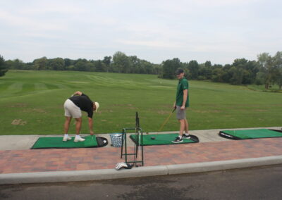 A group of people on a golf course.