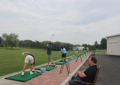 A group of people on a golf course.