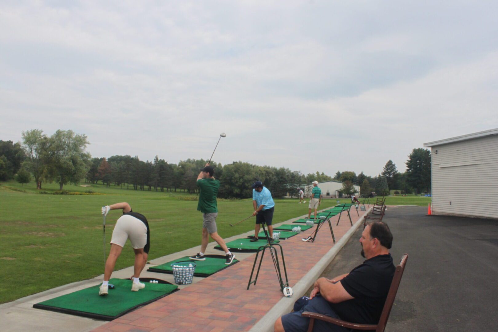 A group of people on a golf course.