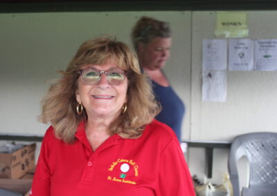 A woman wearing a red polo shirt.