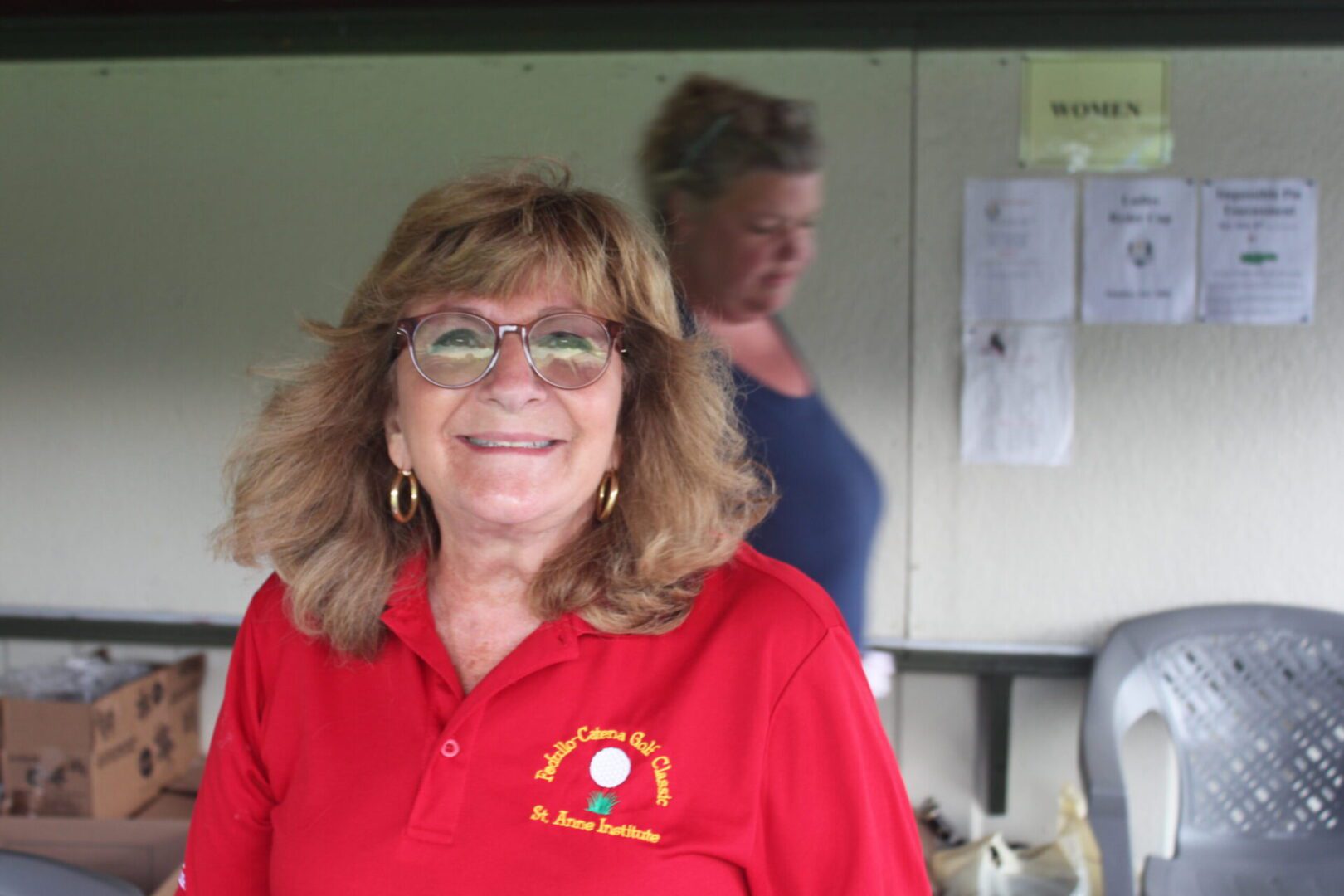 A woman wearing a red polo shirt.
