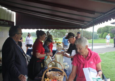 A group of people standing under a tent.