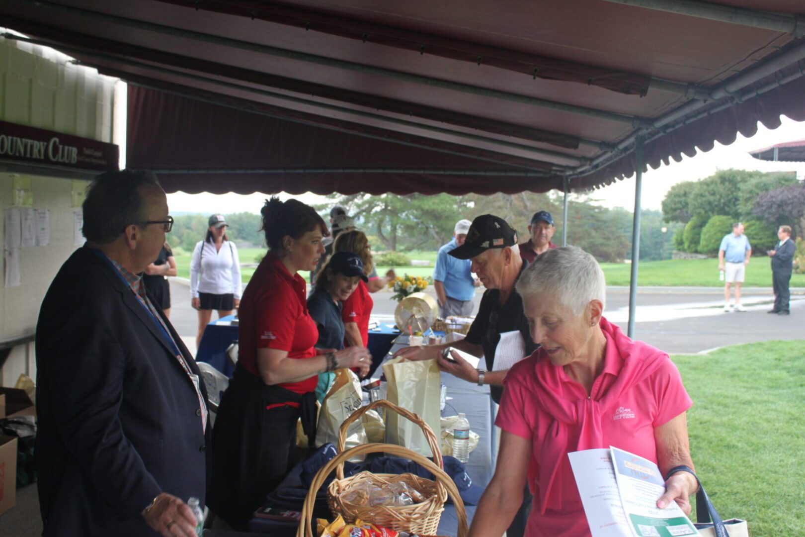 A group of people standing under a tent.