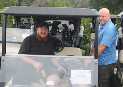 Two men in a golf cart.