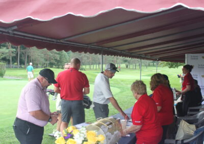 A group of people standing under a tent.