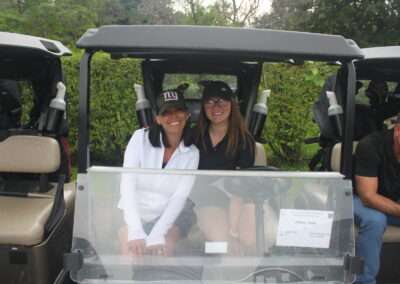 A woman sitting in a golf cart.