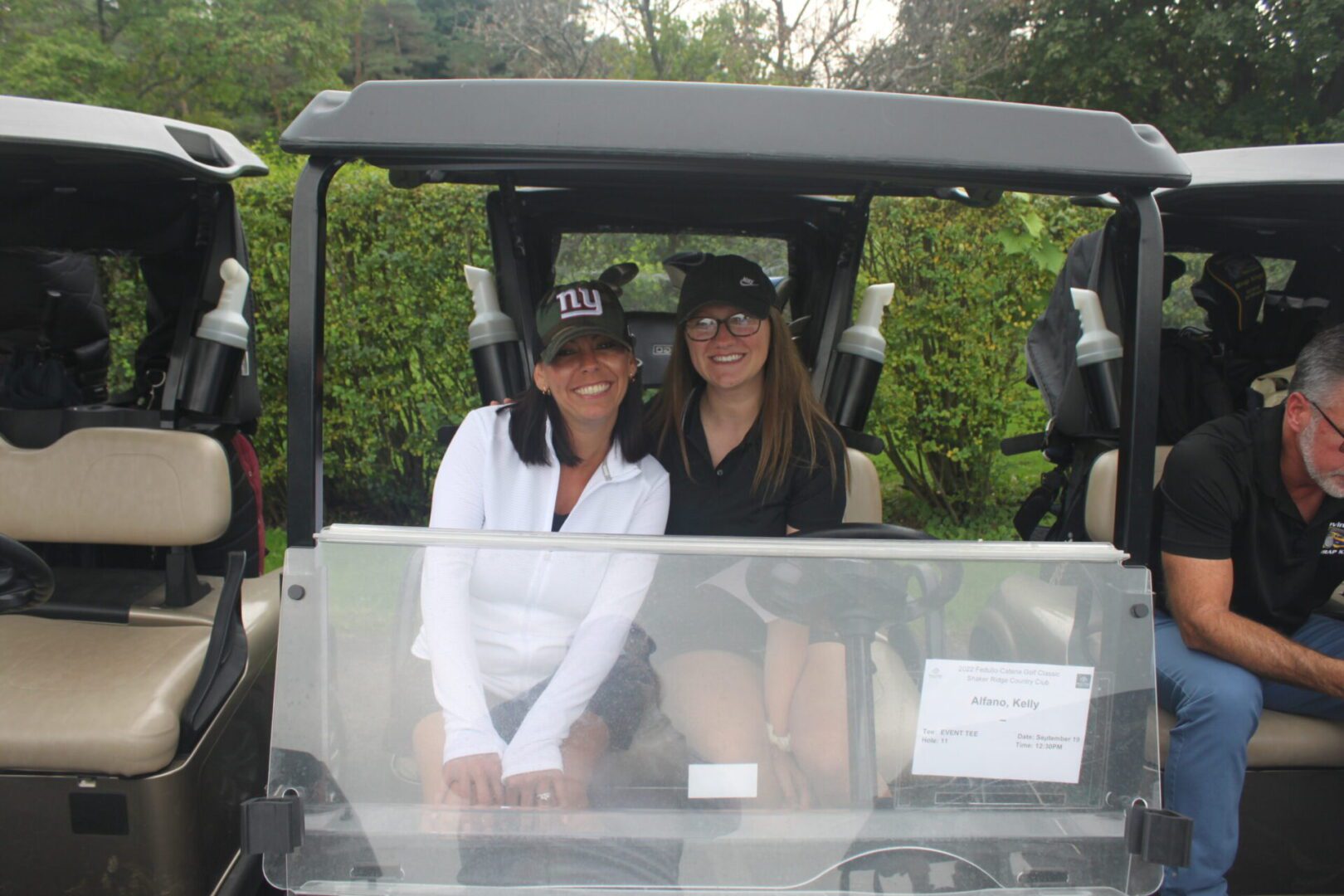 A woman sitting in a golf cart.
