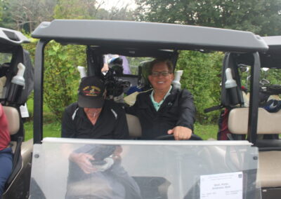 A group of people sitting in a golf cart.