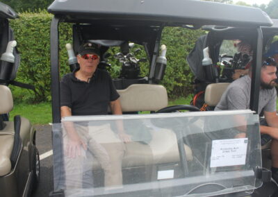 A group of people sitting in a golf cart.