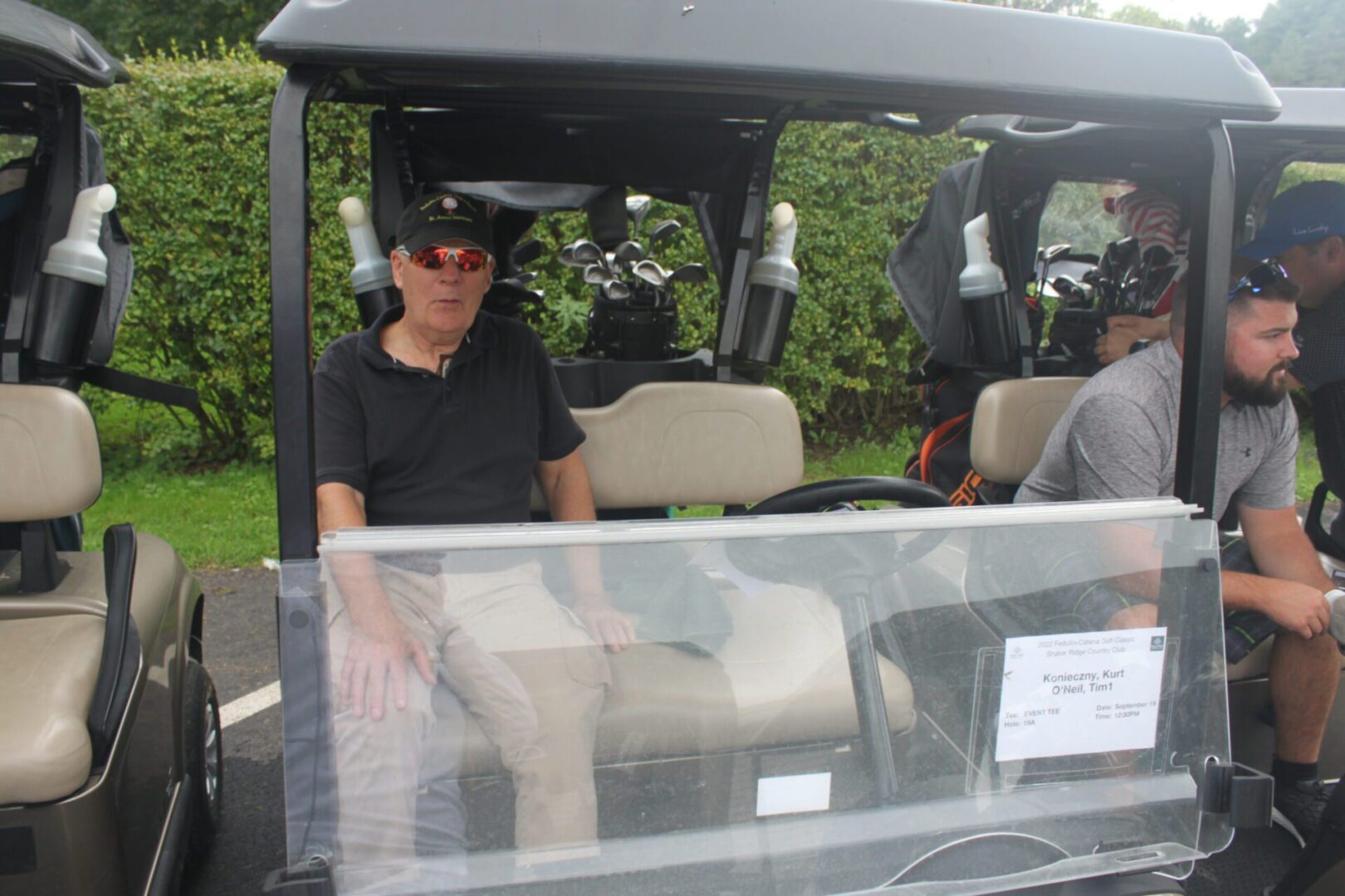 A group of people sitting in a golf cart.