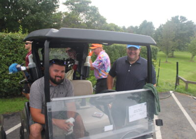 A group of people in a golf cart.