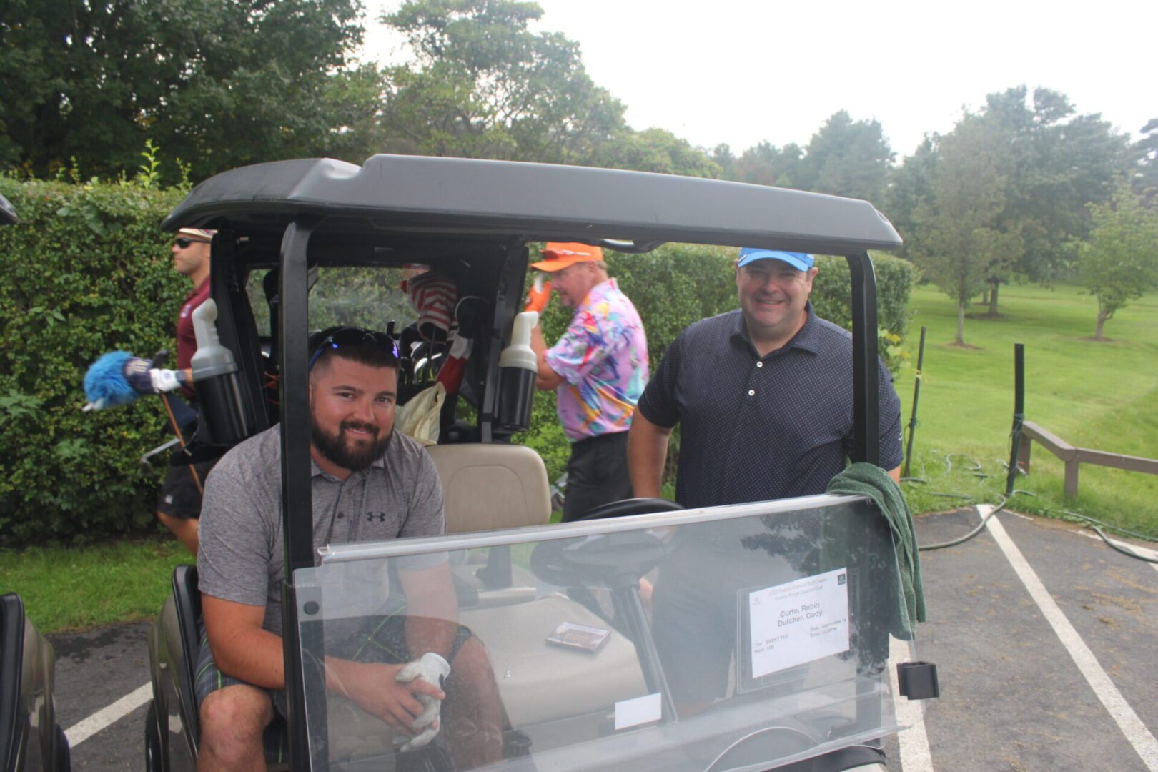 A group of people in a golf cart.
