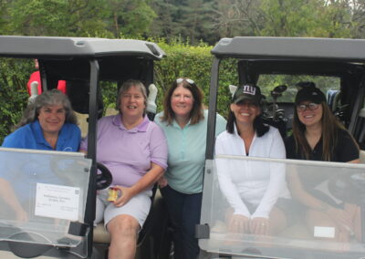 A group of people in a golf cart.