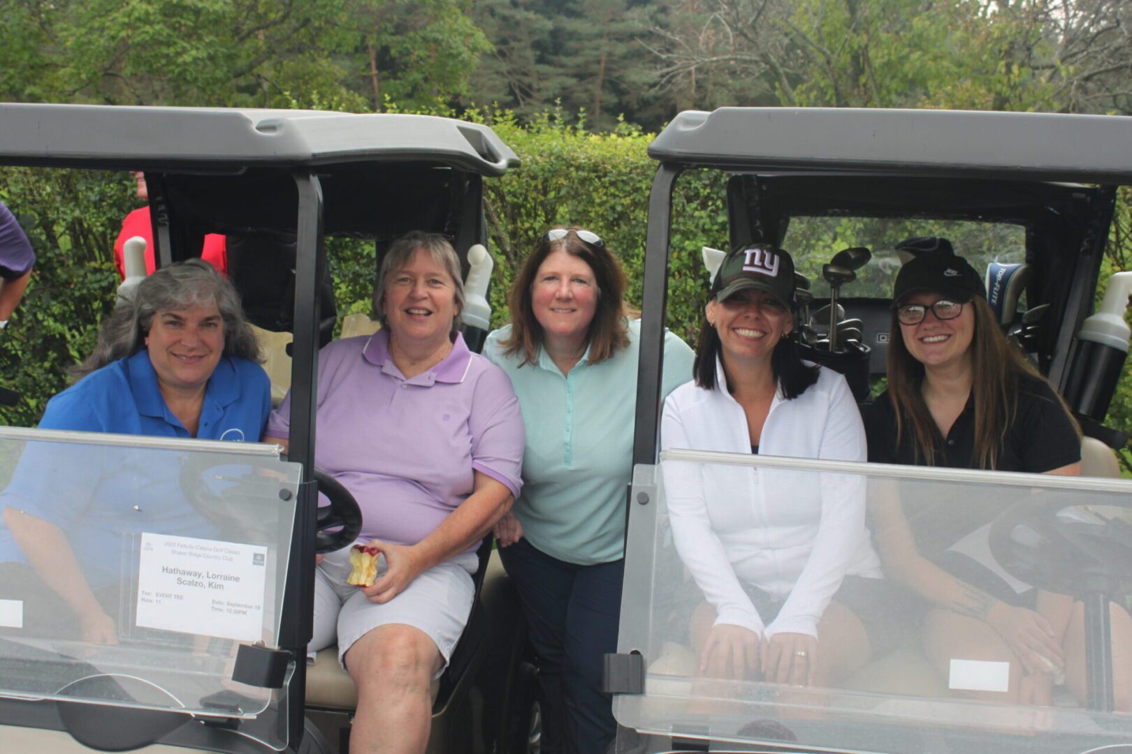A group of people in a golf cart.