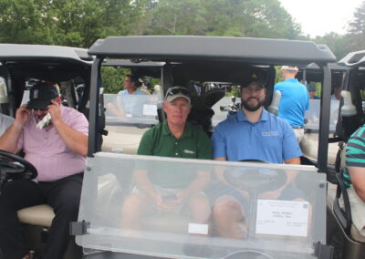 A group of people in golf carts.