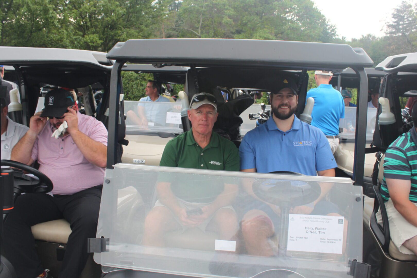 A group of people in golf carts.