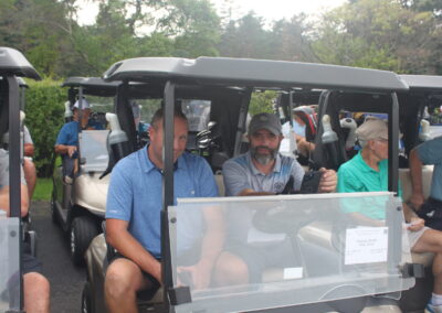 A group of men in golf carts.