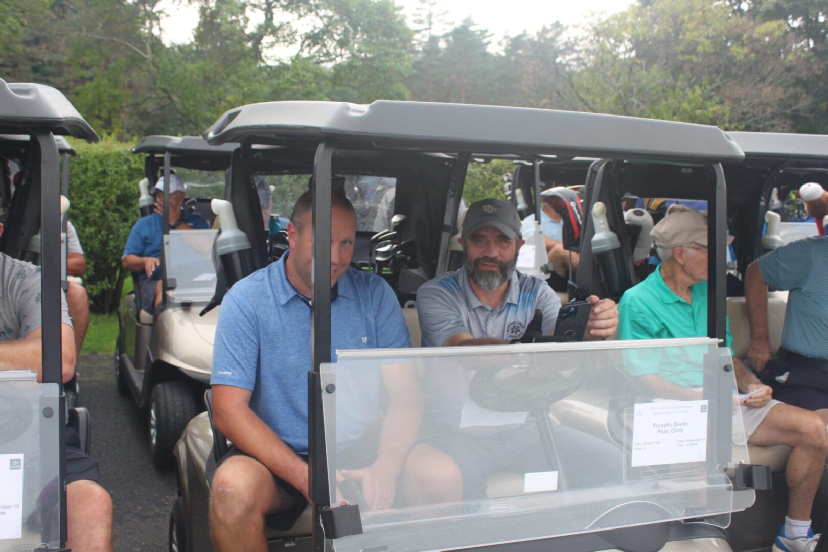 A group of men in golf carts.