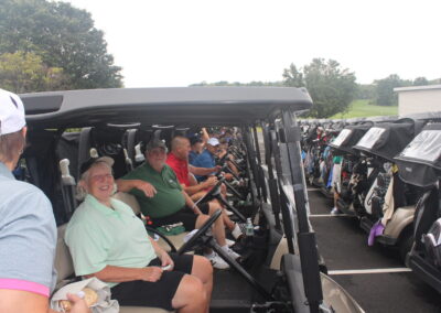 A group of people sitting in golf carts.