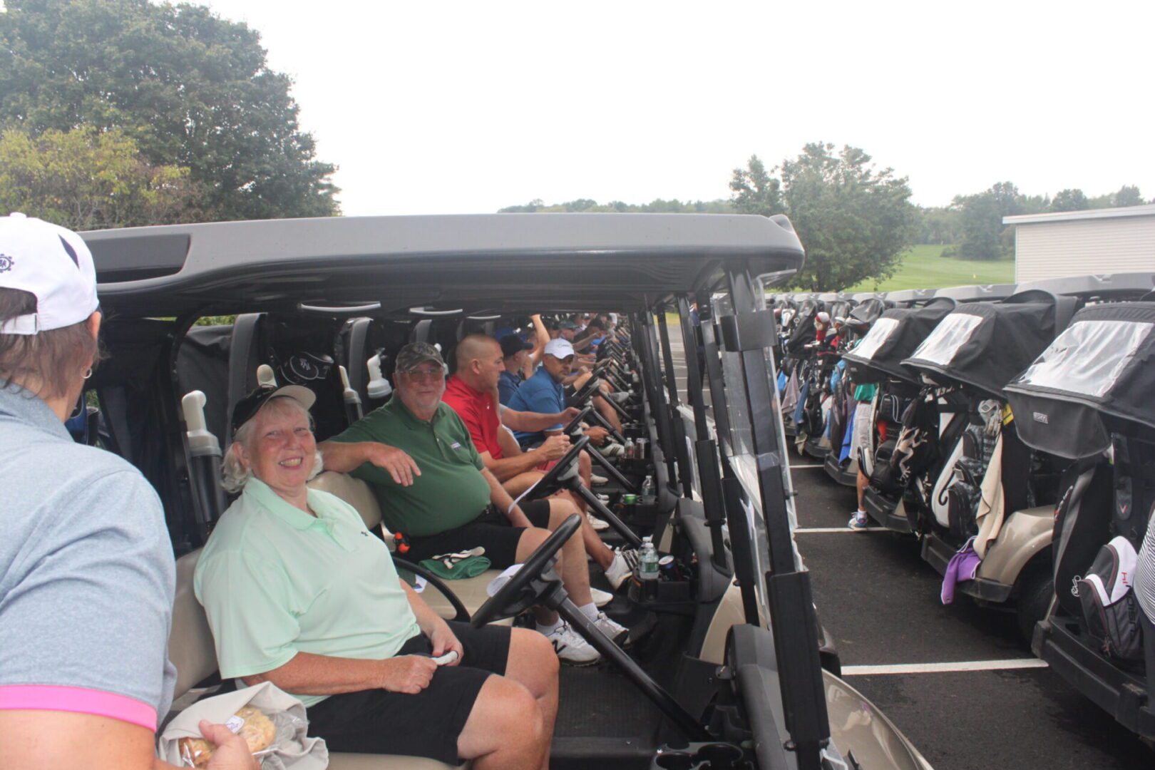 A group of people sitting in golf carts.