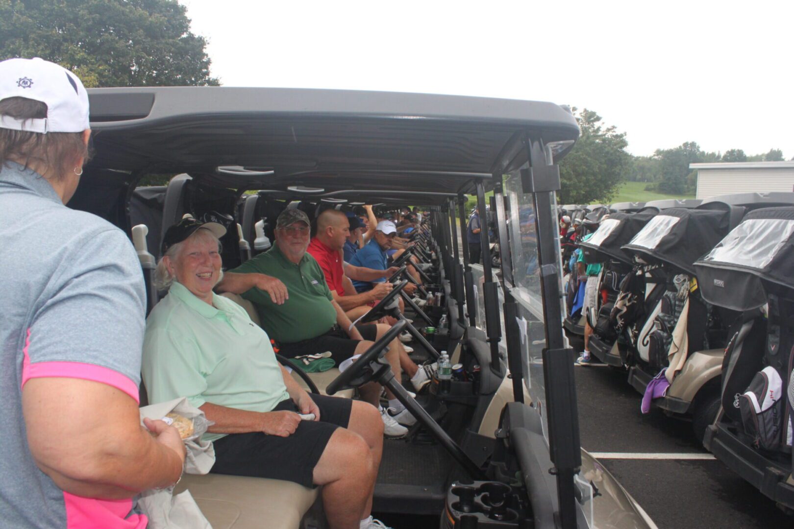 A group of people sitting in a golf cart.