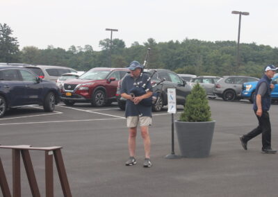 A man is standing in a parking lot.