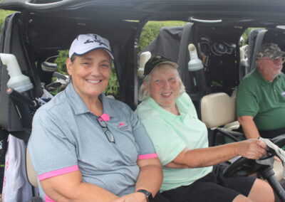 A group of people sitting in a golf cart.