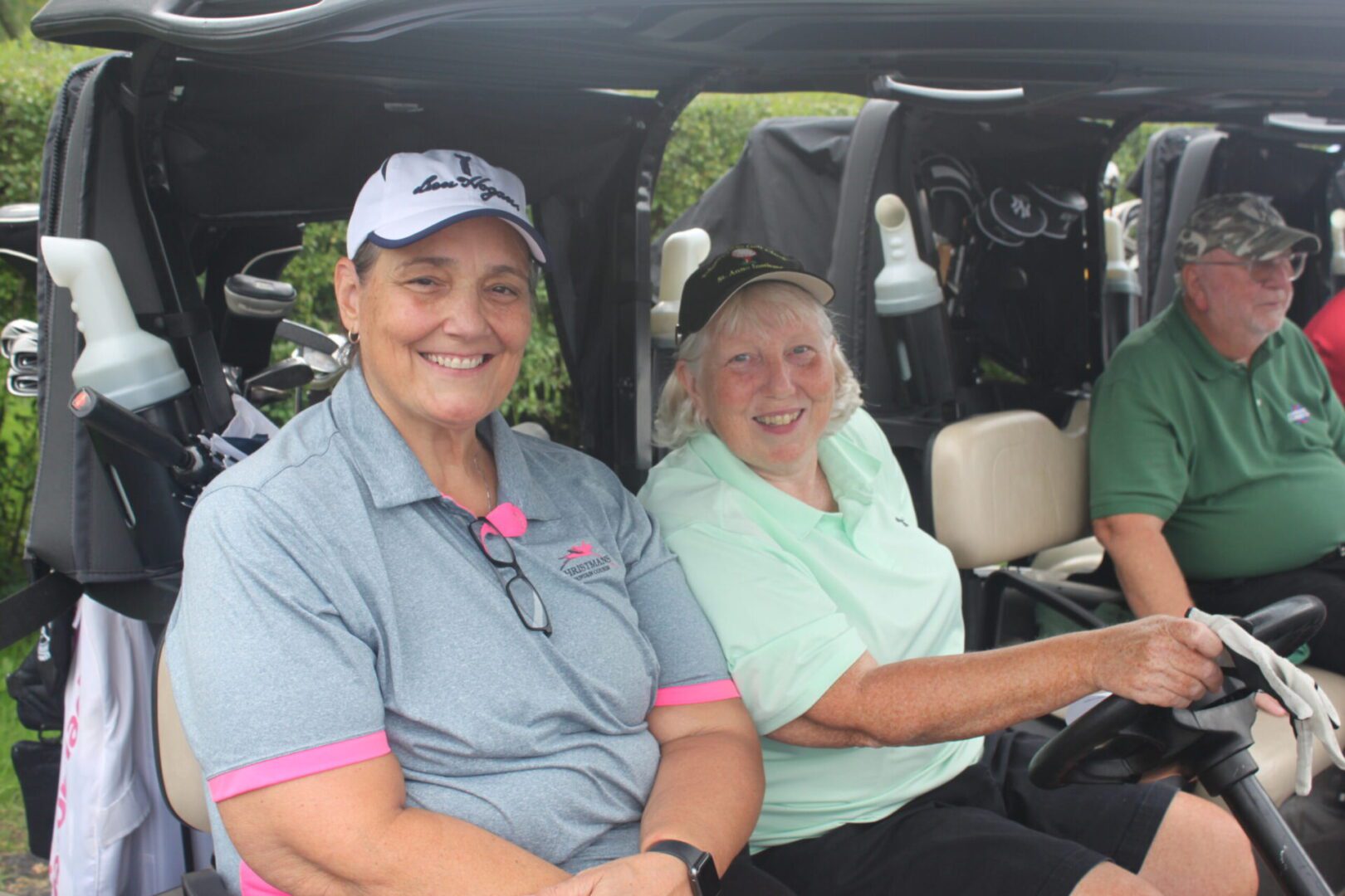 A group of people sitting in a golf cart.
