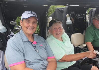 A group of people sitting in a golf cart.