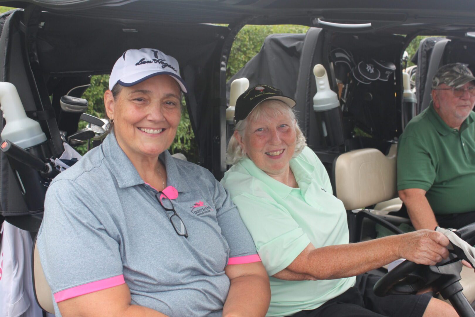 A group of people sitting in a golf cart.
