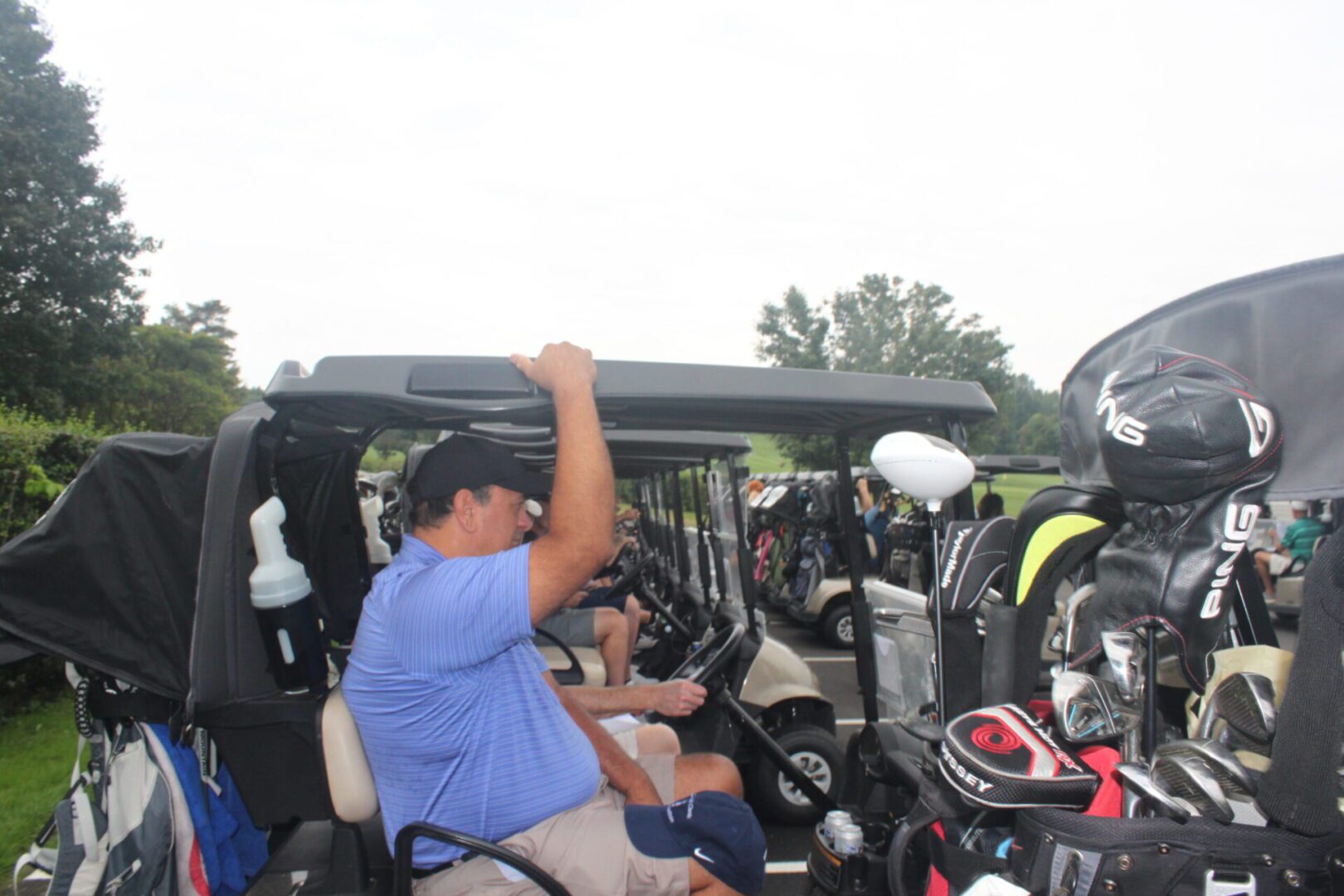A man in a golf cart.